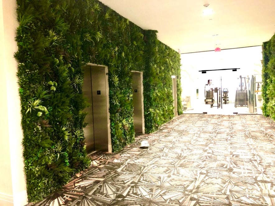 VistaGreen artificial green wall paneling can be mounted to any surface, wood framing was used to fill in depressions in the wall to create a seamless vertical garden look. - Philadelphia PA